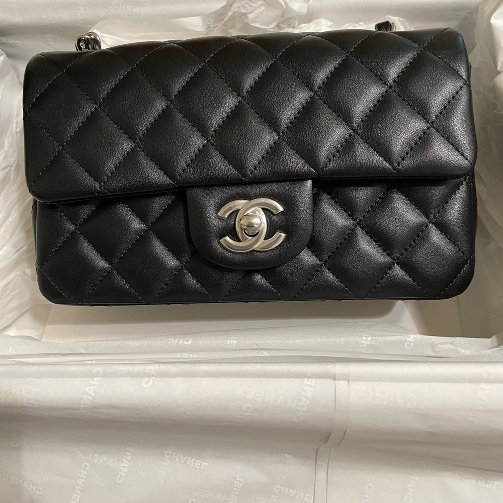 Brand new Chanel mini flap bag in black lambskin and silver handwear